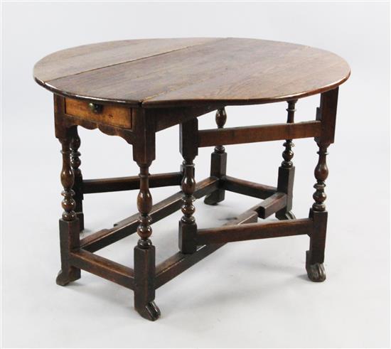 A Queen Anne oval oak gateleg table, extended W.3ft 3in.